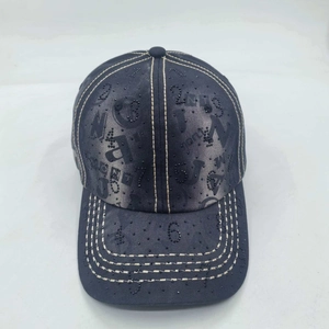 Detail of grey washed denim baseball cap with digital embroidery and rhinestone studs