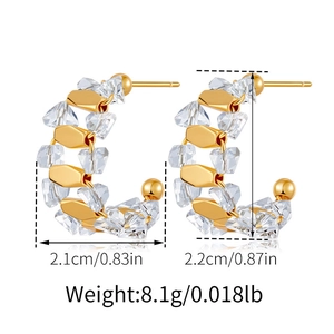 Detail of C-shaped gold earrings with white crystals and size dimensions markers