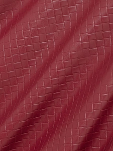 Detailed macro view of high-quality red woven faux leather texture on bomber jacket