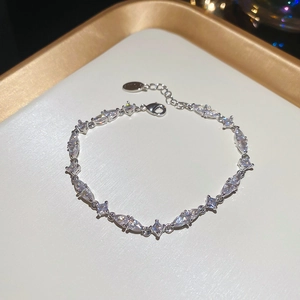 Macro view of silver bracelet with marquise and square cut zircons and lobster clasp