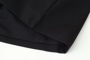 Detailed macro view of black lace fabric texture and premium stitching on the skirt hem