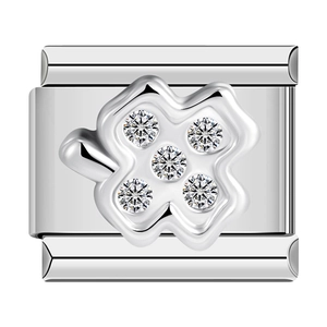 Macro shot of silver metal Italian link charm with four-leaf clover and sparkling gems