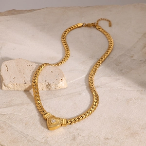 Dettaglio del ciondolo a cuore dorato con diamanti su catena barbazzale piatta