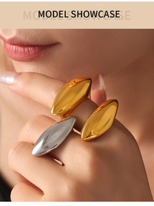 Macro shot of minimalist oval geometric rings in polished gold and silver finishes