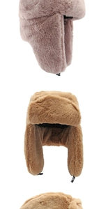 Detail of pink and camel faux fur trapper hats with ear flaps and buckle straps