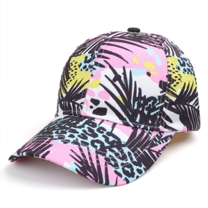 Detail of tropical leaf print and leopard pattern on a casual canvas baseball cap