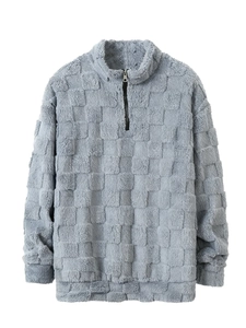 Détail d'un sweat en polaire gris à motif damier texturé avec demi-fermeture éclair