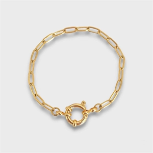 Detail of a gold plated paperclip chain bracelet with a round sailor spring clasp
