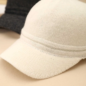 Close-up of premium white wool blend knitted baseball cap with fine texture and soft feel
