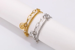 Close-up of double-layered stainless steel star bracelets in gold and silver finish