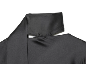 Detail of black satin shirt showing smooth silk texture and neck cutout stitching