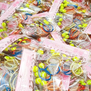 Assorted mini tennis racket keychains with yellow balls in individual bulk packaging