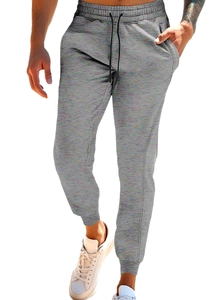 Detail of gray jogger pants showing elastic waistband and black drawstring closure