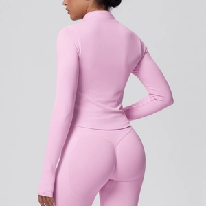 Detail view of pink high-waist fitness leggings with V-shaped seam for butt lift effect