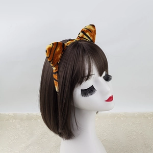 Tiger stripe animal ear headband for Halloween costume made of plush fabric on mannequin head
