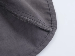 Close-up of high-quality dark grey fabric texture and durable stitching detail