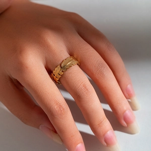 Detail shot of a vintage 18k gold plated stainless steel ring with feather textures