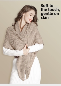 Detail of chunky cable knit shawl in beige with soft texture for winter layering