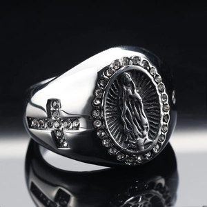 Macro detail of vintage religious ring featuring Virgin Mary relief and cross motifs