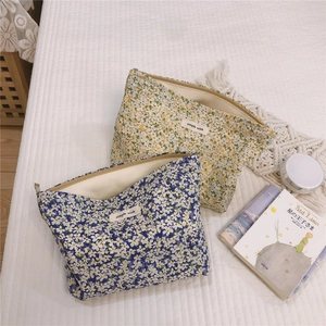 Floral cotton makeup bags with simple wish labels on a white textured background