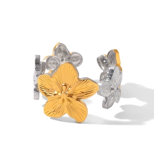 Macro detail of two-tone gold and silver flower ring with detailed petal textures