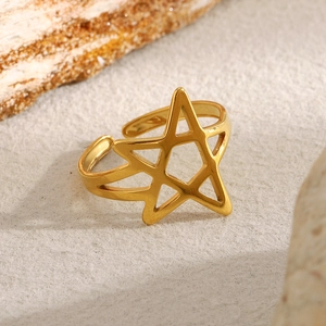Polished 18K gold star open ring for women on a minimalist textured background