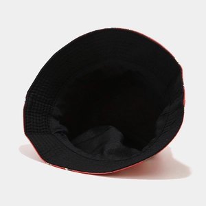 Detail of canvas bucket hat interior showing black lining and red printed brim edge
