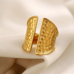 Macro detail of wide 18K gold plated stainless steel ring with hammered texture