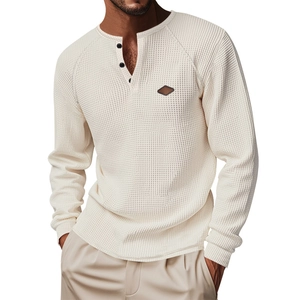 Detailed close-up of waffle knit texture and buttoned Henley collar on men's white long sleeve shirt