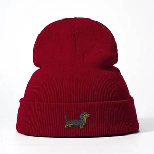 Classic burgundy knit beanie featuring a detailed embroidered dachshund on the cuff
