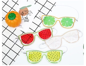 Detail of four fruit pattern gel eye masks including lemon and watermelon for cold therapy
