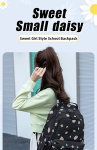 Rear view of a black canvas backpack featuring white daisy prints for students