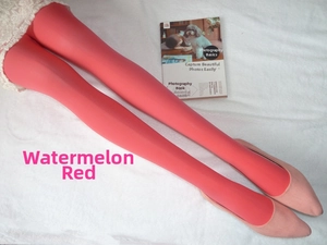 Gros plan sur un collant en velours rouge pastèque et des escarpins assortis sur tapis