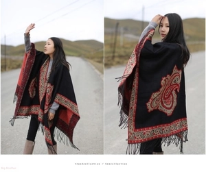 Detail of black bohemian paisley cashmere shawl with elegant fringe and ethnic patterns