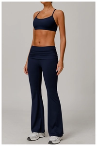 Detail of high-waist yoga flared pants with cross waist design in navy blue finish