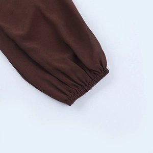 Detailansicht der elastischen Manschette und der leichten braunen Chiffon-Stoffstruktur