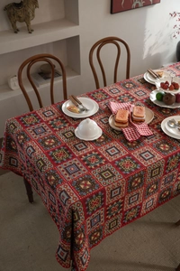 Detail of red Bohemian tablecloth showing geometric woven patterns and fabric texture