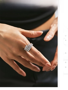Close-up of stacked S925 silver rings with pavé cubic zirconia on a model hand