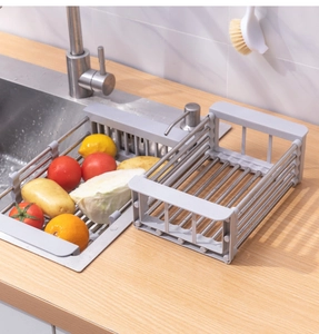 Close-up of telescopic stainless steel sink drainer and countertop dish drying rack set