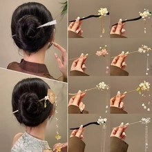Detail view of Chinese tassel hair sticks with floral accents and pearls for traditional updos