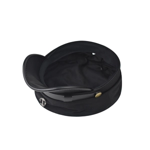 Close-up of black sailor cap featuring silver anchor badge and gold buttons detail