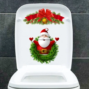 Macro detail of Santa Claus wreath decal applied on a white bathroom toilet lid