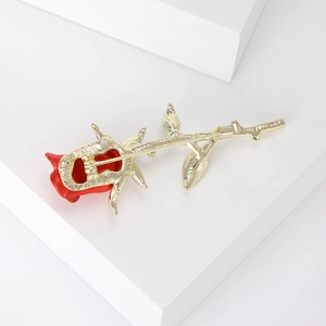 Back view of luxury red rose brooch with golden stem and pin on white blocks