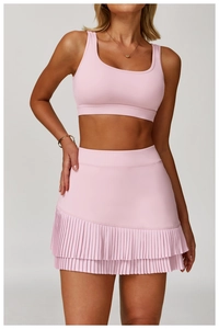 Detail of pink sports top and layered pleated skirt with high-quality elastic fabric