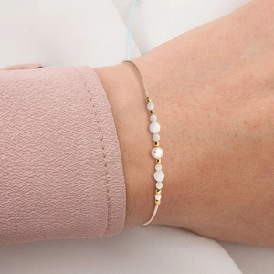 Handmade pearl and gemstone beaded bracelet with gold accents for elegant women