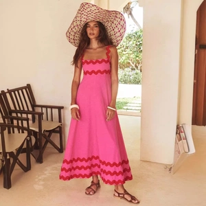 Elegant pink and red floral maxi sundress with ruffle trim shown on a model