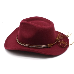 Detail of burgundy felt cowboy hat with double-row metal beads and rhinestone band