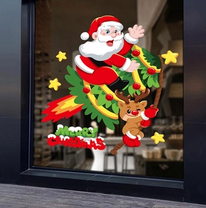 Close-up of Santa Claus and reindeer window stickers on dark glass for Christmas decor