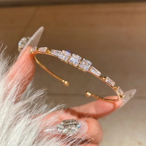 Detailed close-up of 18K gold plated open bangle with sparkling cubic zirconia stones