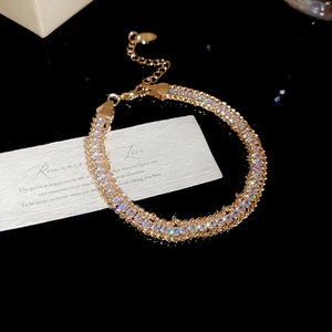 Detail of gold crystal wrap chain bracelet with lobster clasp on a gift box